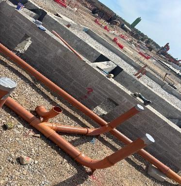 Underground drainage pipework being laid and connected on site